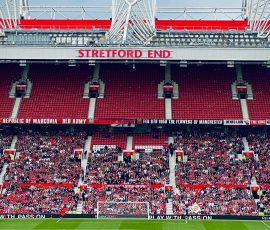 View of the Stretford End crowd at Manchester's iconic stadium during a day event.